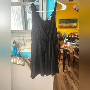 Black mini dress with tie neck closure.